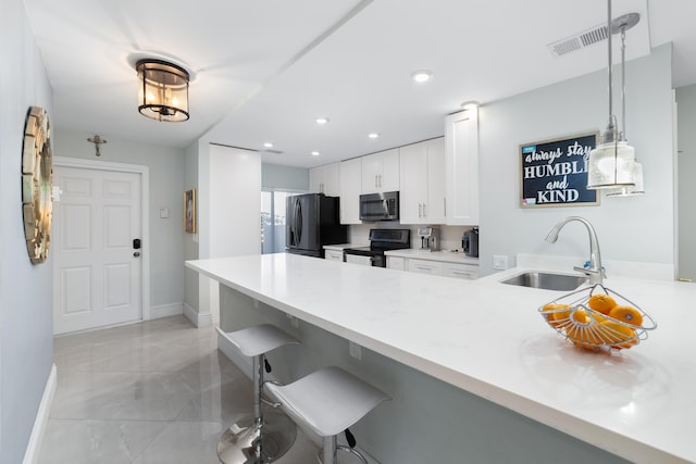 kitchen with stainless steel appliances, a sink, a peninsula, a breakfast bar, and baseboards