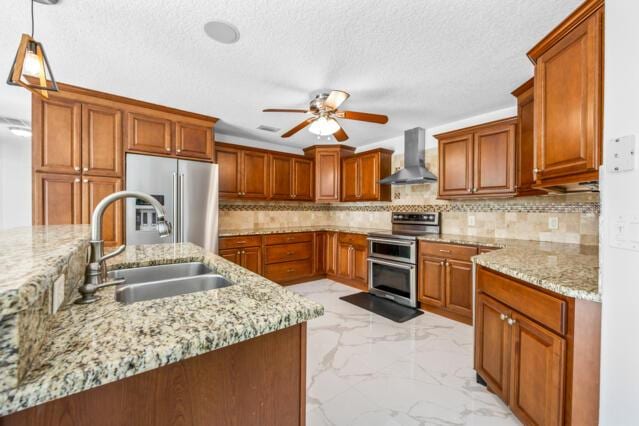 kitchen with ceiling fan, a sink, marble finish floor, stainless steel appliances, and range hood
