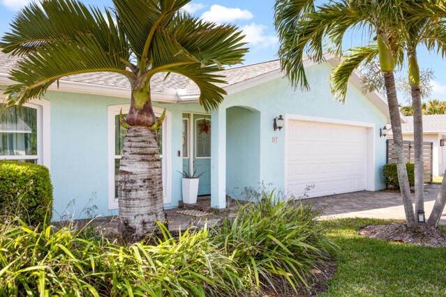 view of front of property with an attached garage, stucco siding, and driveway