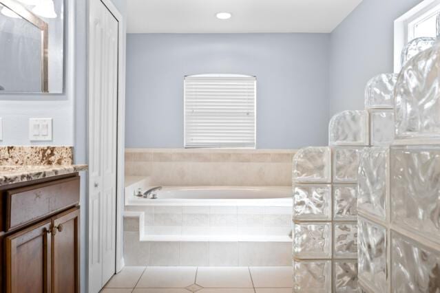 bathroom with vanity, tile patterned floors, a garden tub, and recessed lighting
