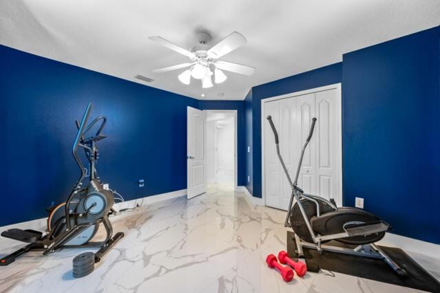 exercise room featuring baseboards, marble finish floor, ceiling fan, and visible vents
