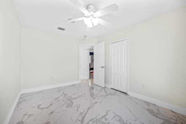 unfurnished bedroom featuring baseboards, visible vents, and marble finish floor