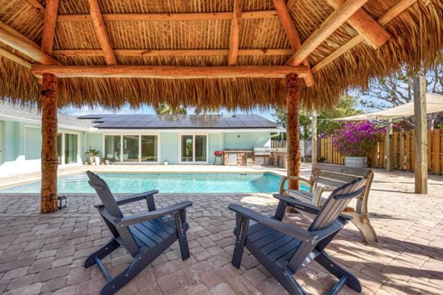 view of pool with fence, a gazebo, area for grilling, a fenced in pool, and a patio area