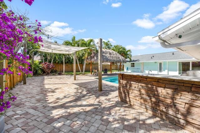 view of swimming pool featuring a fenced in pool, a fenced backyard, and a patio area