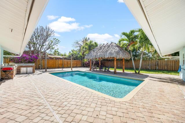 view of pool featuring a fenced backyard, a fenced in pool, a patio, and a gazebo