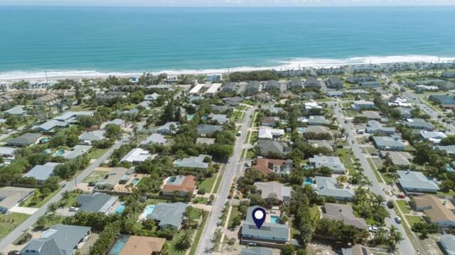 drone / aerial view with a beach view and a water view