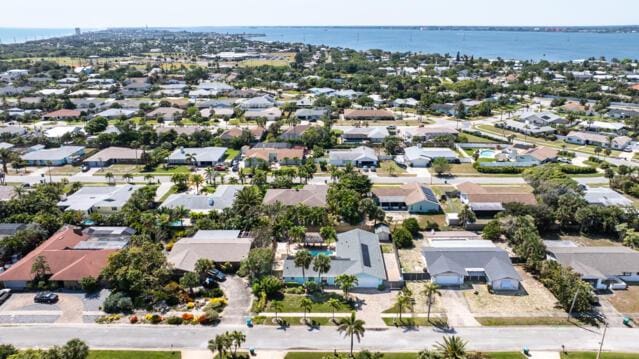 drone / aerial view featuring a residential view and a water view