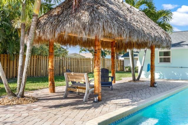exterior space with a fenced in pool, fence, and a gazebo