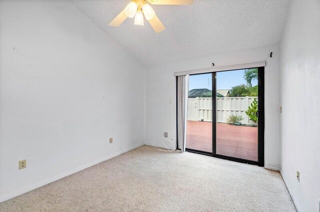5578 Golden Eagle Cir Unit 5578, Palm Beach Gardens, FL 33418 - spare room with a textured ceiling, vaulted ceiling, carpet flooring, a ceiling fan, and baseboards