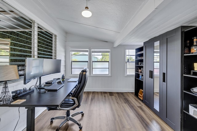 home office with baseboards, vaulted ceiling with beams, a textured ceiling, and wood finished floors