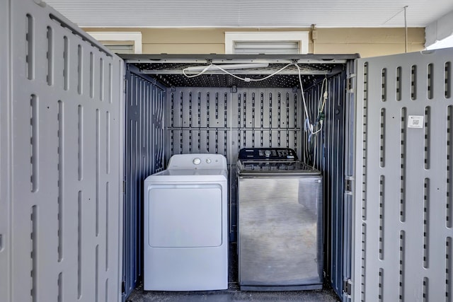 washroom featuring laundry area and washing machine and clothes dryer