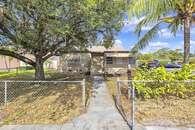 view of front of property with a fenced front yard and crawl space