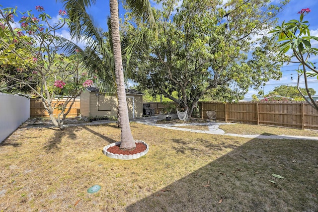 view of yard featuring an outdoor structure and a fenced backyard