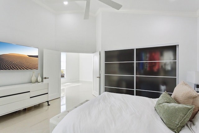 tiled bedroom featuring ensuite bathroom, ornamental molding, and a high ceiling