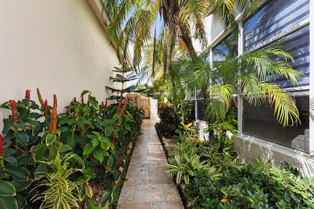 view of side of home with fence and stucco siding