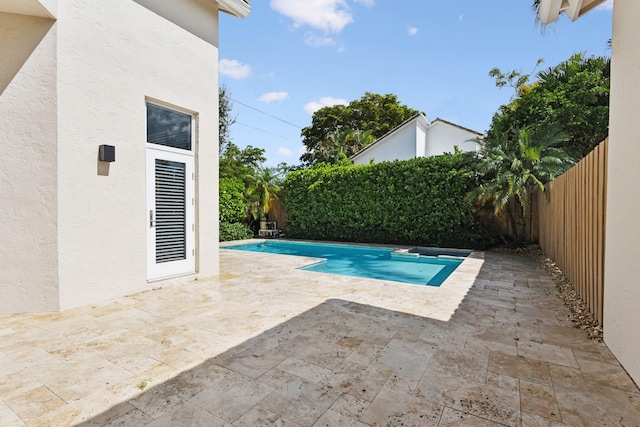 view of swimming pool featuring a fenced backyard, a fenced in pool, and a patio