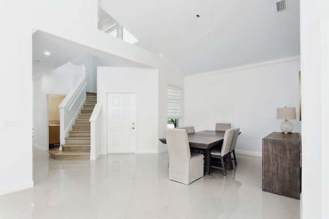 dining space featuring crown molding, tile patterned floors, baseboards, visible vents, and stairway