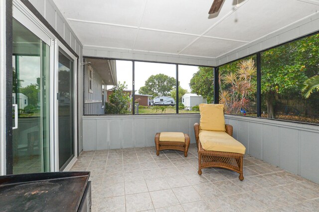 sunroom / solarium featuring ceiling fan
