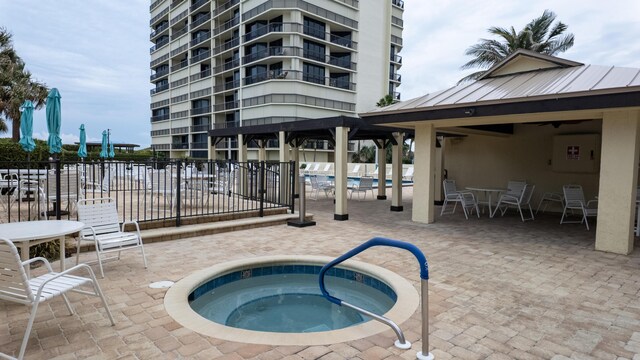 9500 S Ocean Dr Unit 1502, Jensen Beach, FL 34957 - view of pool featuring a community hot tub, fence, a patio, a gazebo, and a swimming pool