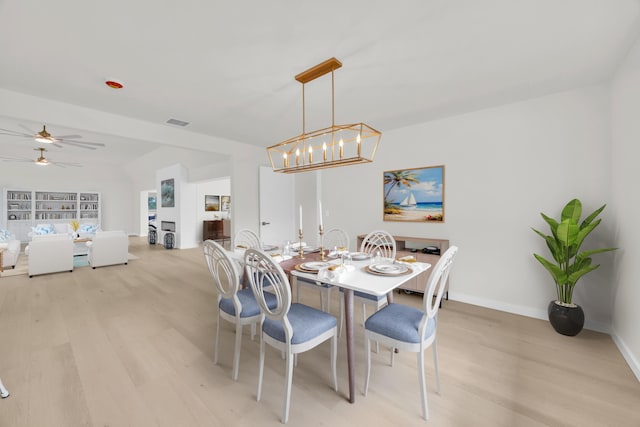 4372 SW Bimini Cir N, Palm City, FL 34990 - dining room featuring light wood-style flooring, a chandelier, ceiling fan, and baseboards