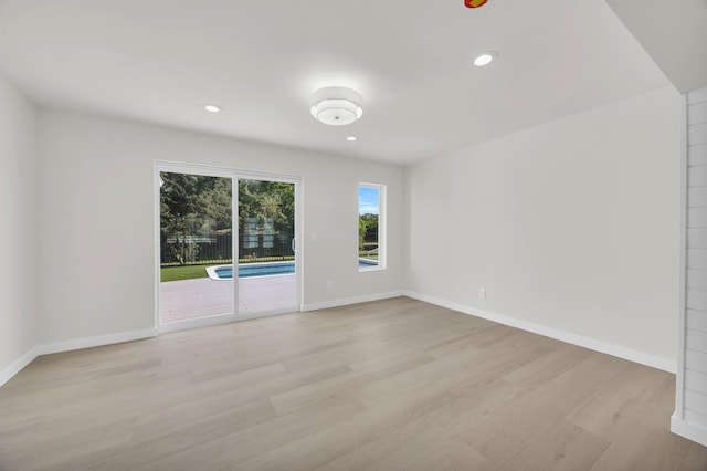 4372 SW Bimini Cir N, Palm City, FL 34990 - empty room featuring plenty of natural light, light wood finished floors, recessed lighting, and baseboards