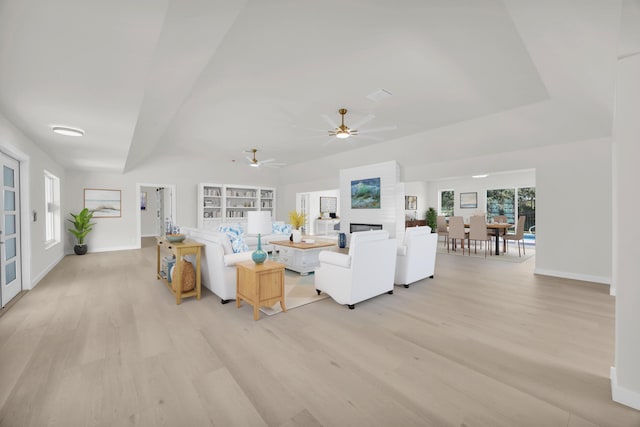 4372 SW Bimini Cir N, Palm City, FL 34990 - living area featuring light wood-style flooring, ceiling fan, baseboards, and a fireplace