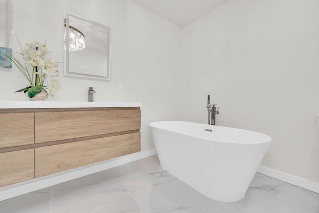 4372 SW Bimini Cir N, Palm City, FL 34990 - full bathroom with marble finish flooring, baseboards, a soaking tub, and vanity