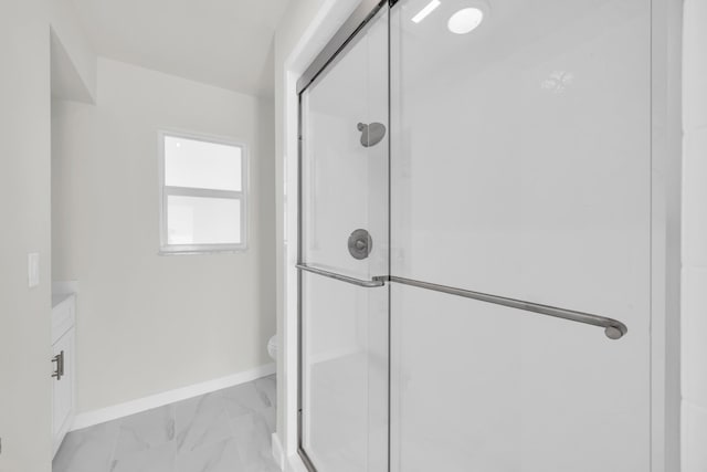 4372 SW Bimini Cir N, Palm City, FL 34990 - bathroom with marble look tile flooring, a shower stall, toilet, and baseboards