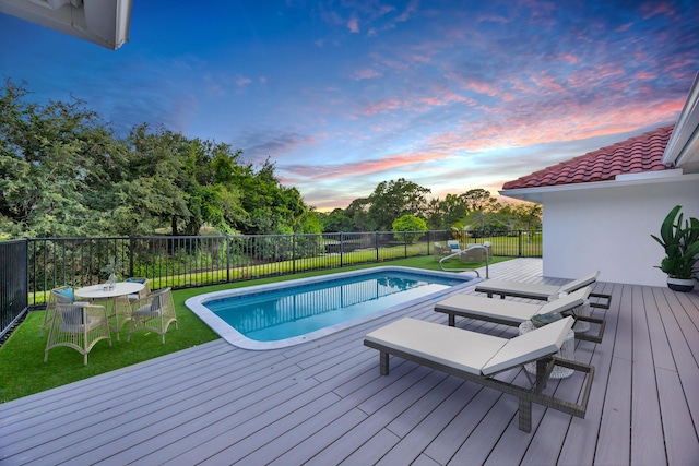 4372 SW Bimini Cir N, Palm City, FL 34990 - pool at dusk with a deck and outdoor dining area