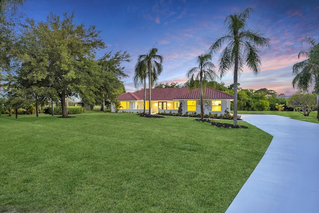 4372 SW Bimini Cir N, Palm City, FL 34990 - ranch-style house with driveway, a tiled roof, and a front lawn