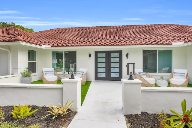 4372 SW Bimini Cir N, Palm City, FL 34990 - doorway to property featuring stucco siding, fence, french doors, and a tile roof