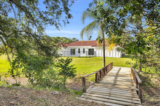 4372 SW Bimini Cir N, Palm City, FL 34990 - back of property featuring a tiled roof and stucco siding