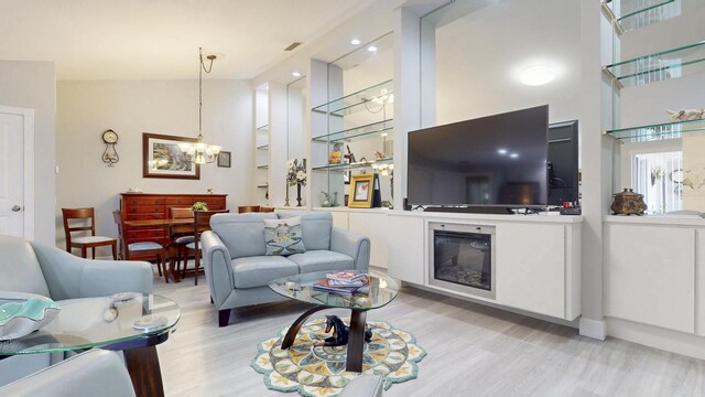 dining room featuring light wood-type flooring, recessed lighting, baseboards, and a notable chandelier