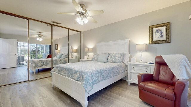 bedroom featuring visible vents, baseboards, connected bathroom, a ceiling fan, and light wood-style flooring
