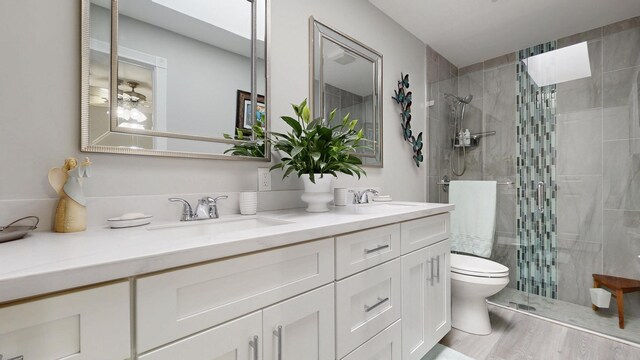 full bath featuring a sink, double vanity, wood finished floors, and visible vents