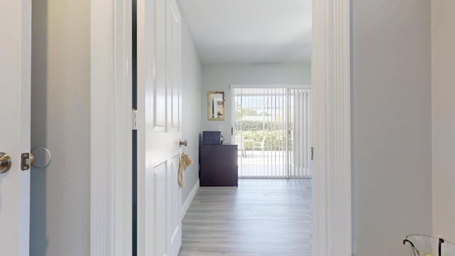 hall featuring baseboards and wood finished floors