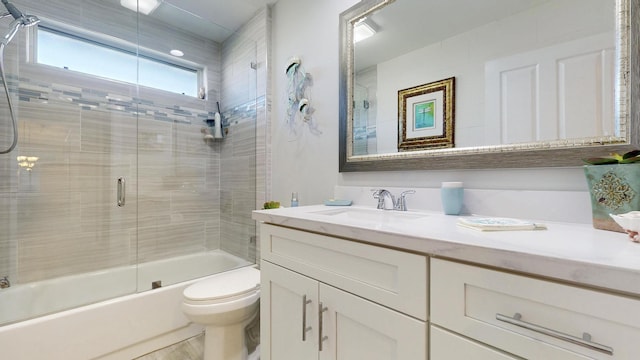 full bathroom with toilet, enclosed tub / shower combo, and vanity