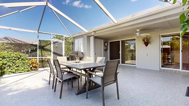 view of patio featuring ceiling fan, a lanai, and outdoor dining space