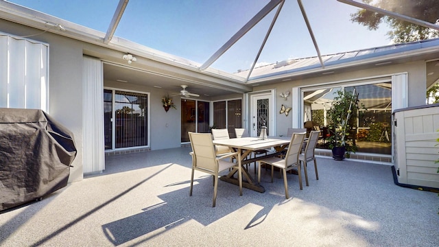 view of patio featuring ceiling fan, a lanai, and outdoor dining space
