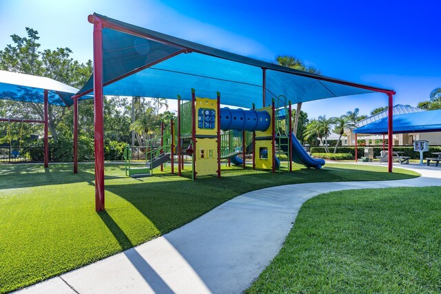 communal playground featuring a lawn