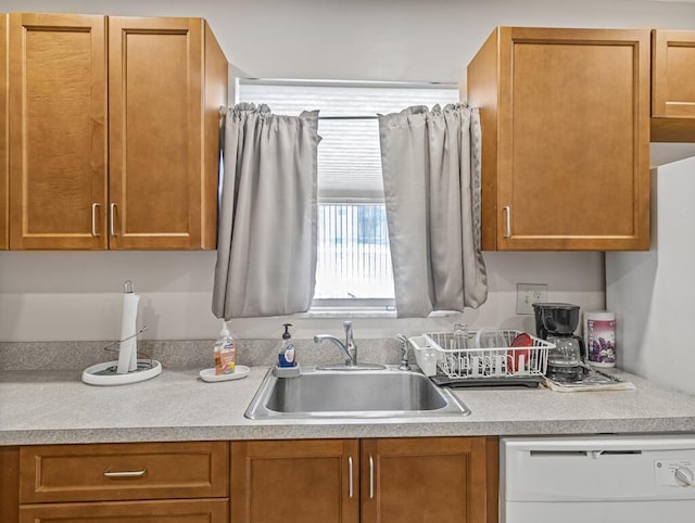 103 Oxford 500 Unit 103, West Palm Beach, FL 33417 - kitchen with white dishwasher, a sink, light countertops, and brown cabinets