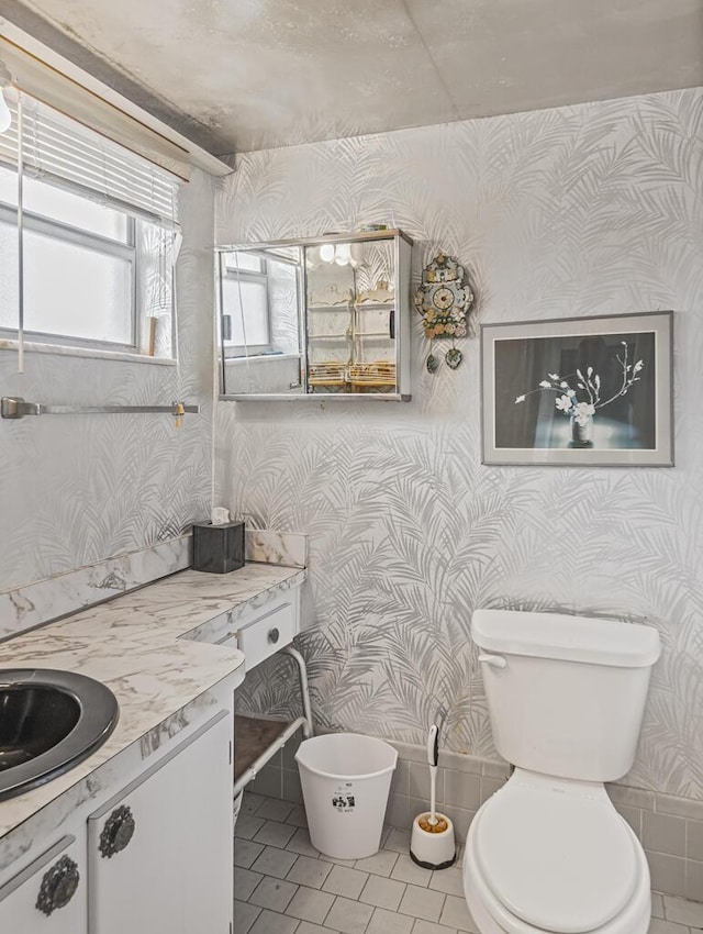 103 Oxford 500 Unit 103, West Palm Beach, FL 33417 - bathroom with wallpapered walls, tile patterned flooring, vanity, and toilet