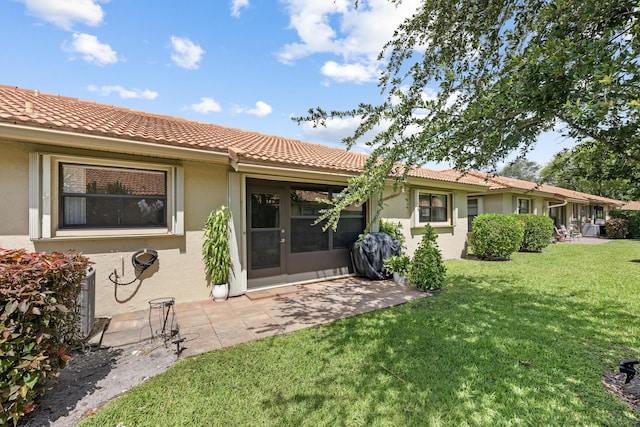 4670 Laurel Tree Rd Unit A, Boynton Beach, FL 33436 - back of house featuring a tiled roof, stucco siding, a lawn, and a patio area