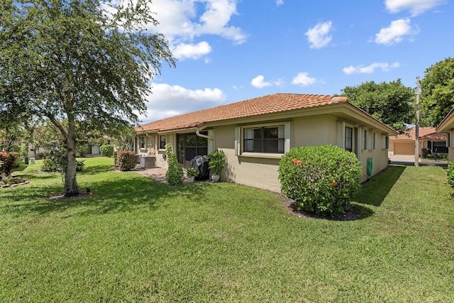 4670 Laurel Tree Rd Unit A, Boynton Beach, FL 33436 - back of property featuring a tile roof, stucco siding, a yard, and central AC unit