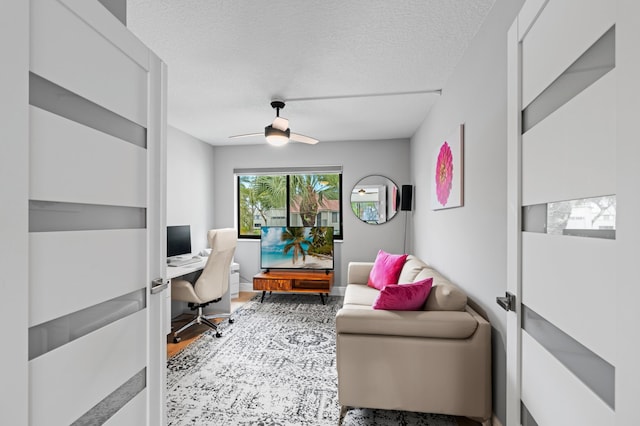 office space with a textured ceiling, ceiling fan, and wood finished floors