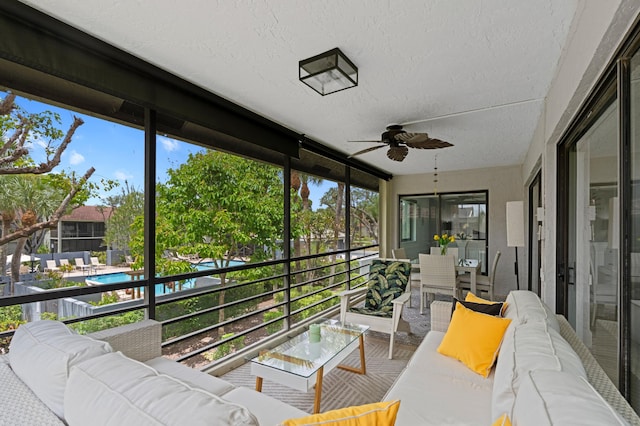 sunroom with an outdoor living space and a ceiling fan