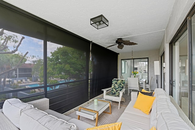 sunroom / solarium with an outdoor living space and ceiling fan