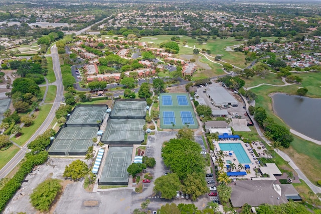drone / aerial view with a water view and golf course view