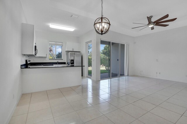 340 Pioneer Way, Royal Palm Beach, FL 33411 - unfurnished living room with light tile patterned floors and ceiling fan with notable chandelier
