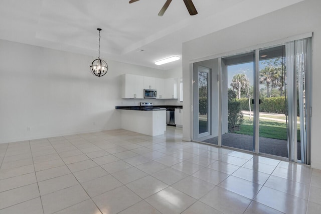 340 Pioneer Way, Royal Palm Beach, FL 33411 - unfurnished living room with ceiling fan with notable chandelier and light tile patterned floors
